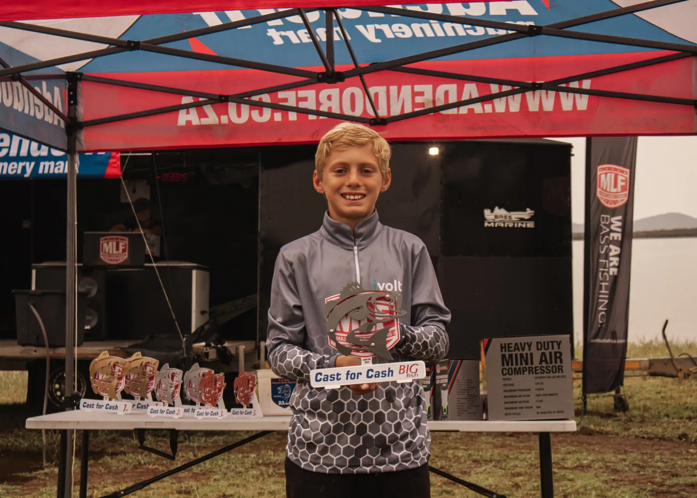 Junior angler with a trophy bass on the water